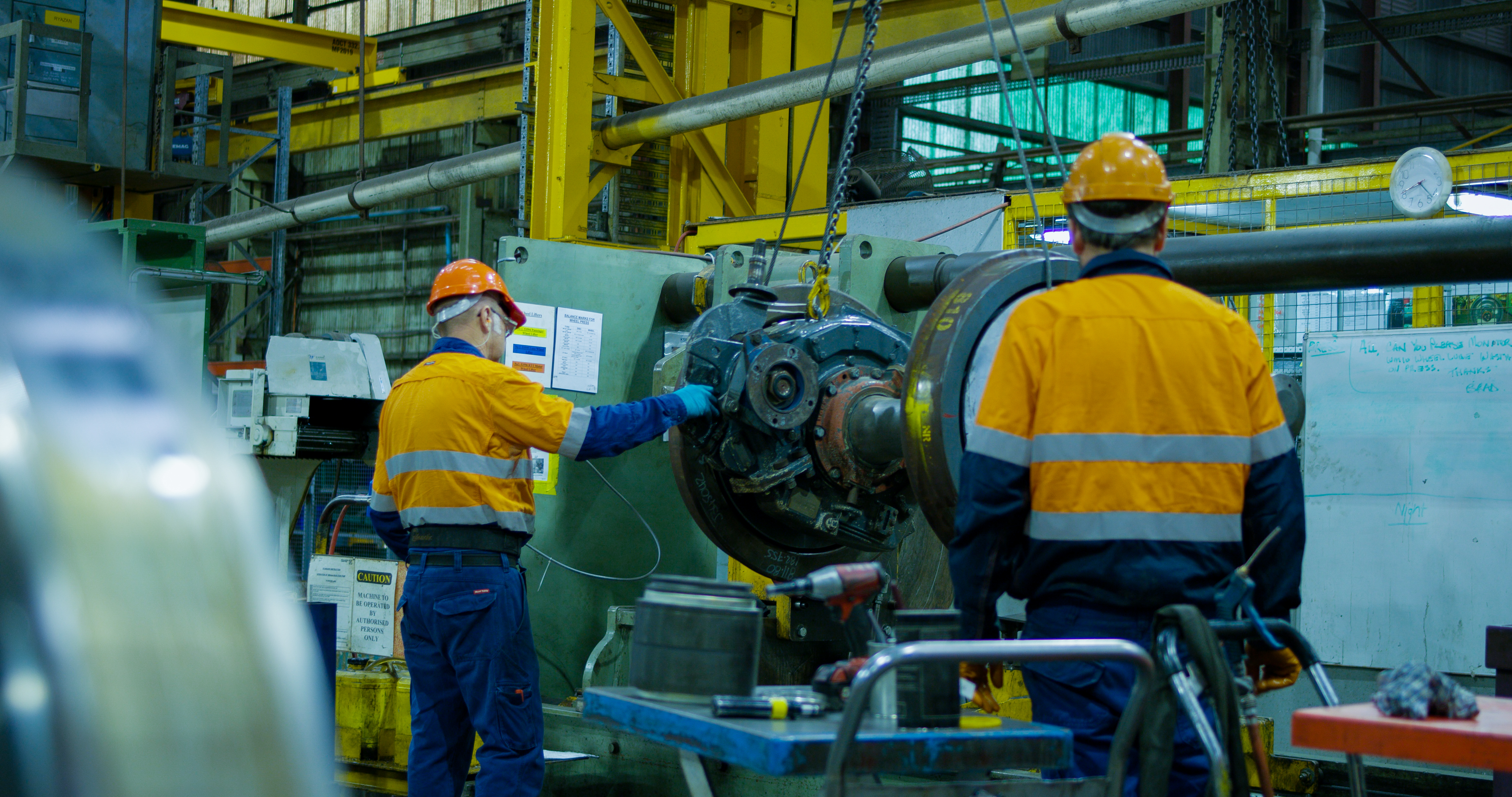 Two workers in front of railway rolling stock factory